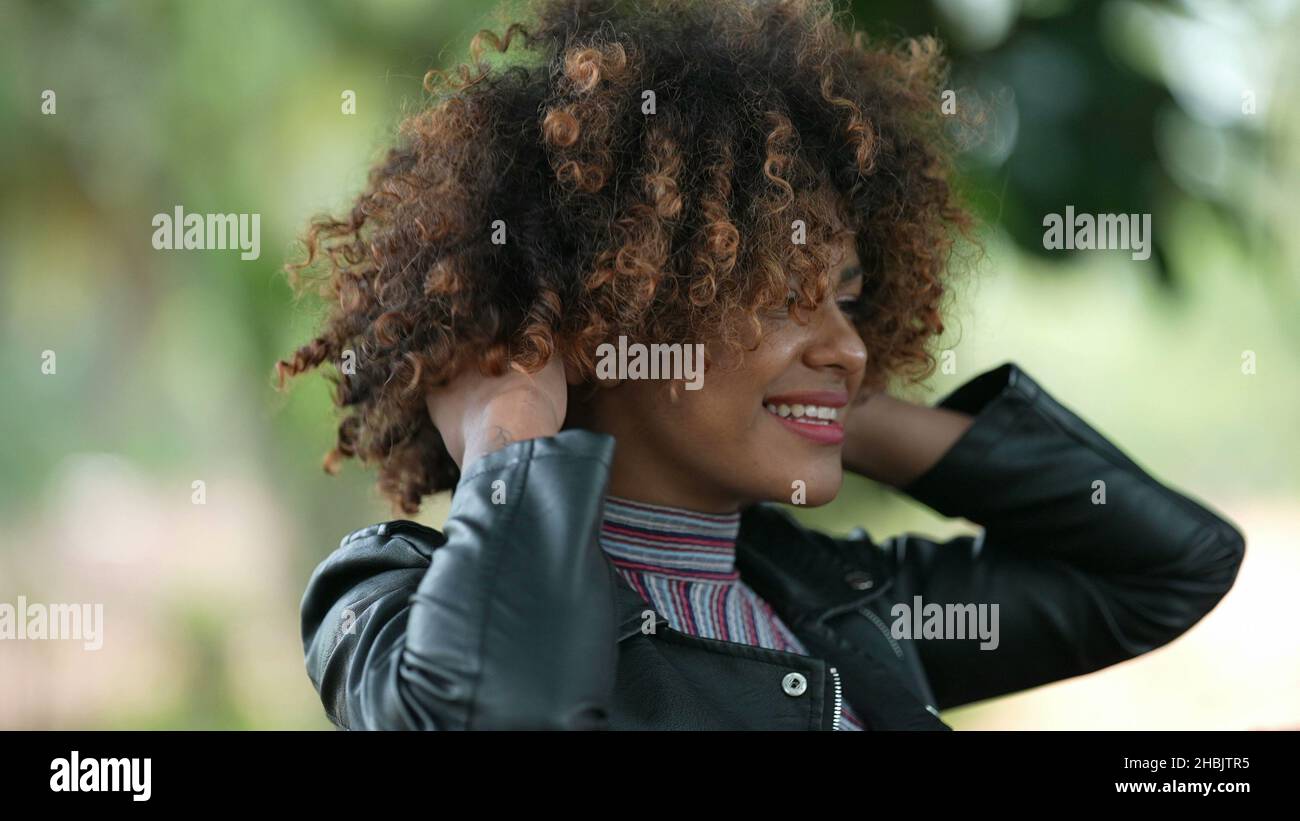 Adjusting woman curly hair hi-res stock photography and images - Alamy