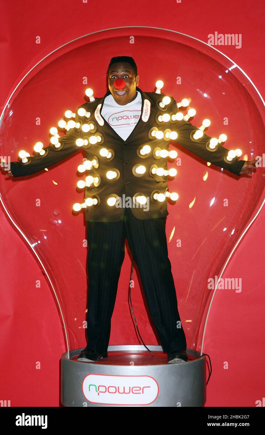 Lenny Henry dons his light bulb jacket and attempts to break out of a giant light bulb to highlight the partnership between Comic Relief and npower, at the Holborn Studios in central London, February 5, 2007. Stock Photo