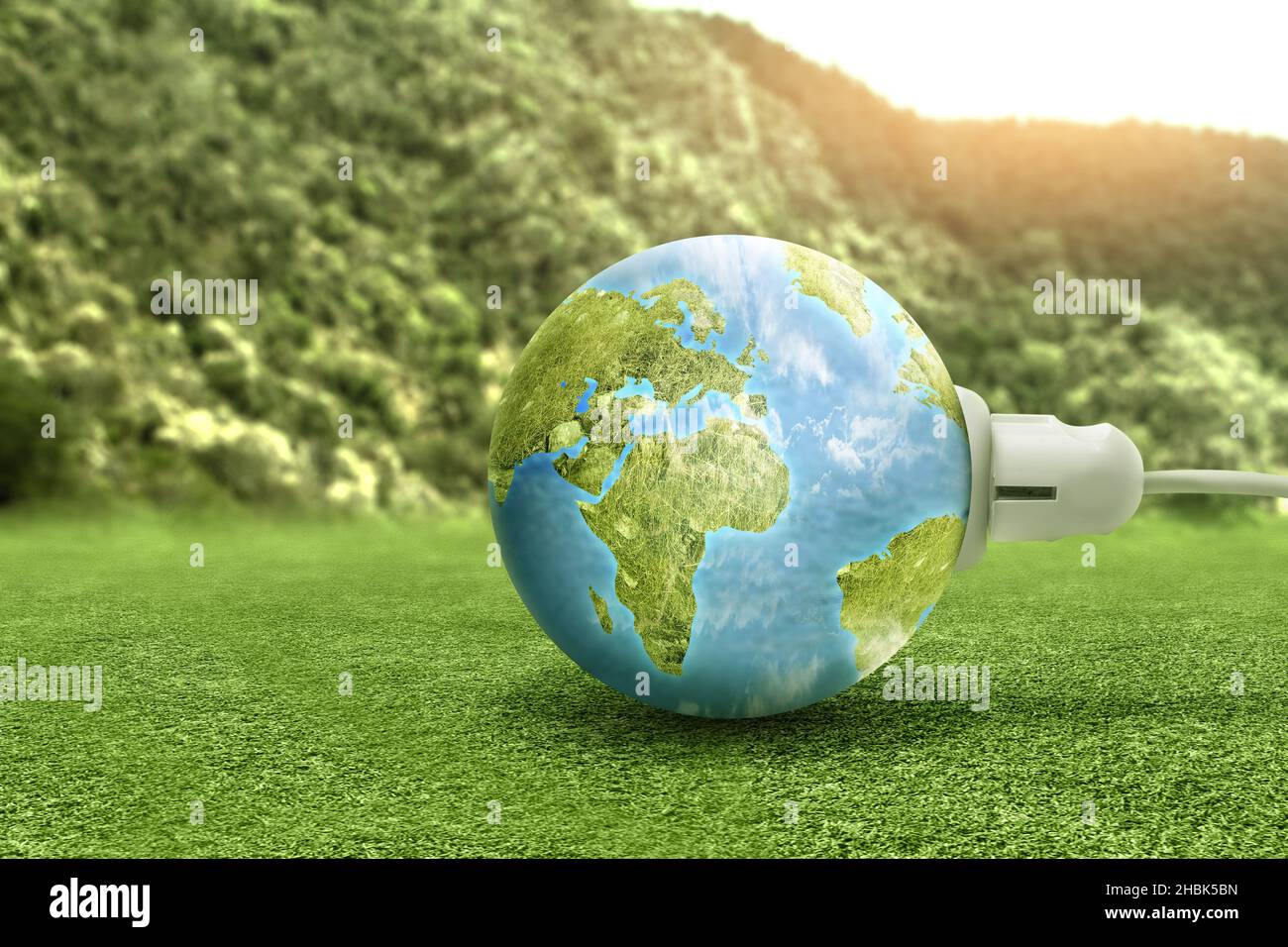 Electric plug into an earth power socket. Green Power Concept Stock