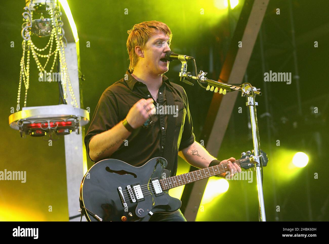 Josh Homme and his band Queens of the Stone Age perform on stage at the O2 Wireless Festival at Hyde Park, London. Stock Photo