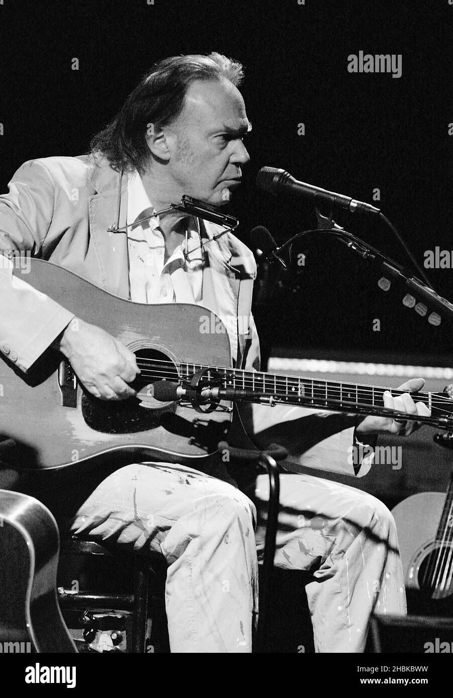 Neil Young performing the acoustic half of his concert at the Hammersmith Apollo in west London. Stock Photo