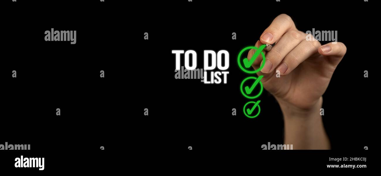 To do list with checklist boxes. Hand marking with pen on a black background, banner Stock Photo