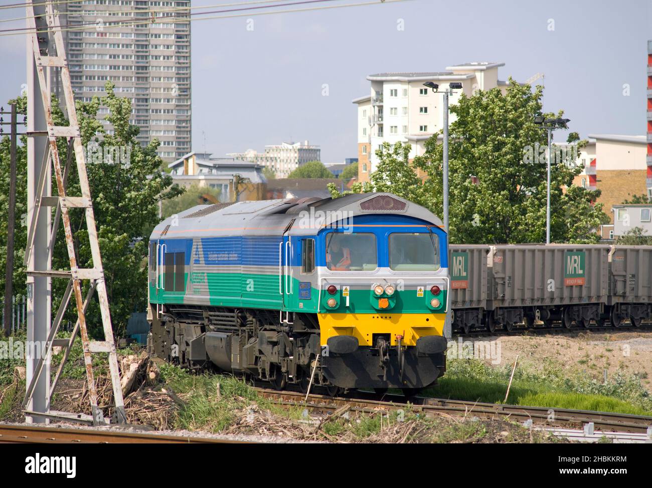 An Aggregates Industries Class 59 diesel locomotive number 59005 'Kenneth J Painter' stands in Bow yard in east London with empty stone wagons. Stock Photo
