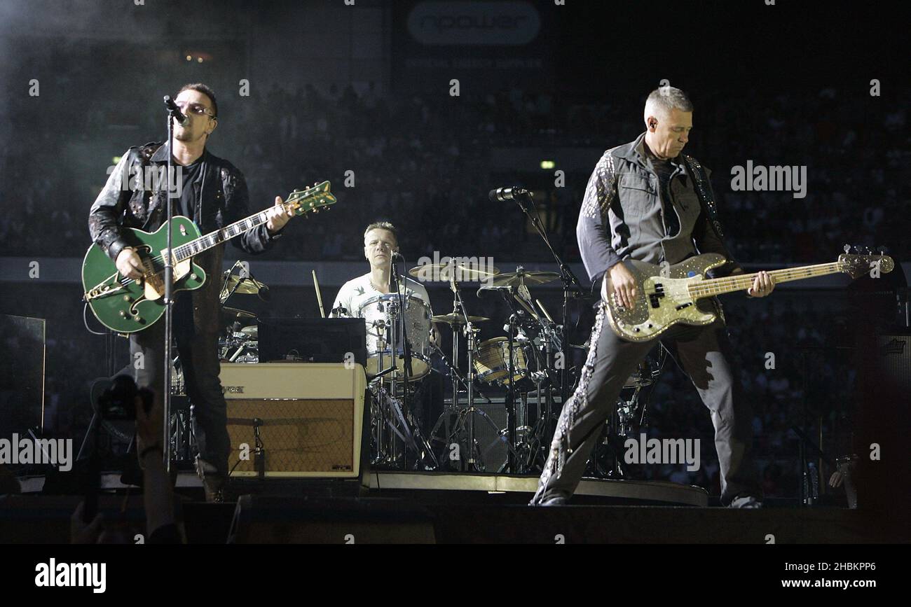 The Edge, Bono and Adam Clayton perform with U2 at Wembley Stadium in London, UK Stock Photo