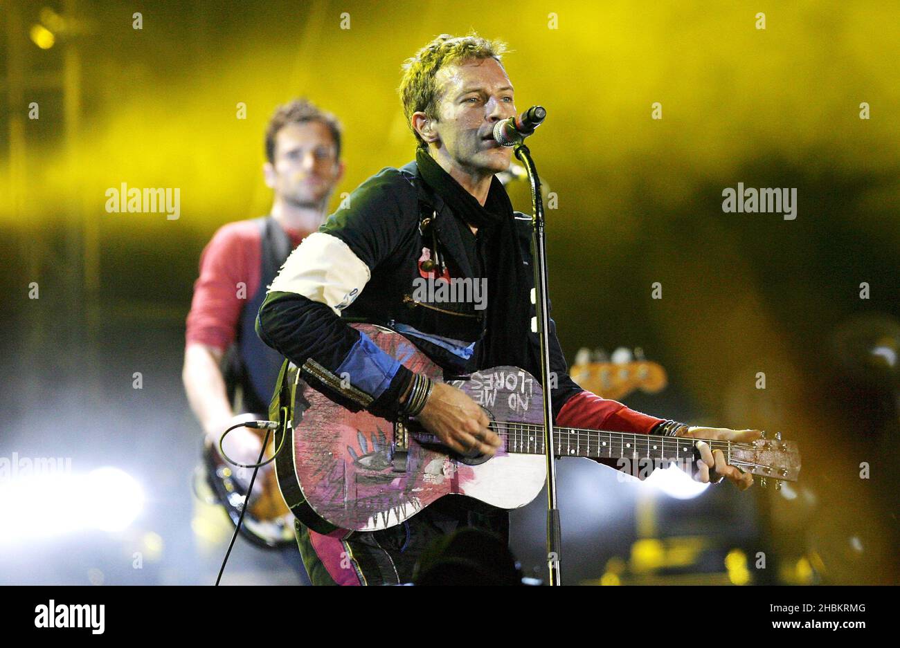 Chris Martin of Coldplay performs on stage at Wembley Stadium, North London. Stock Photo