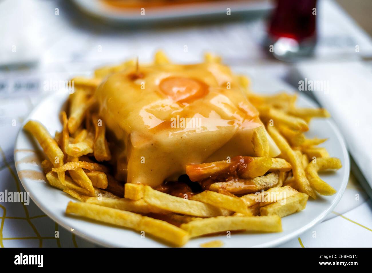 Delicious traditional francesinha served with french fries, Porto, Portugal Stock Photo