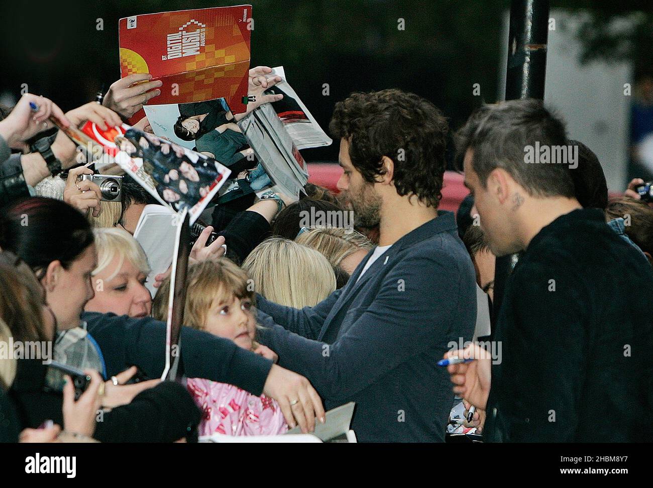 Howard Donald Robbie Wiliams of Take That signing autographs for fans at Radio 1 in central London. Stock Photo