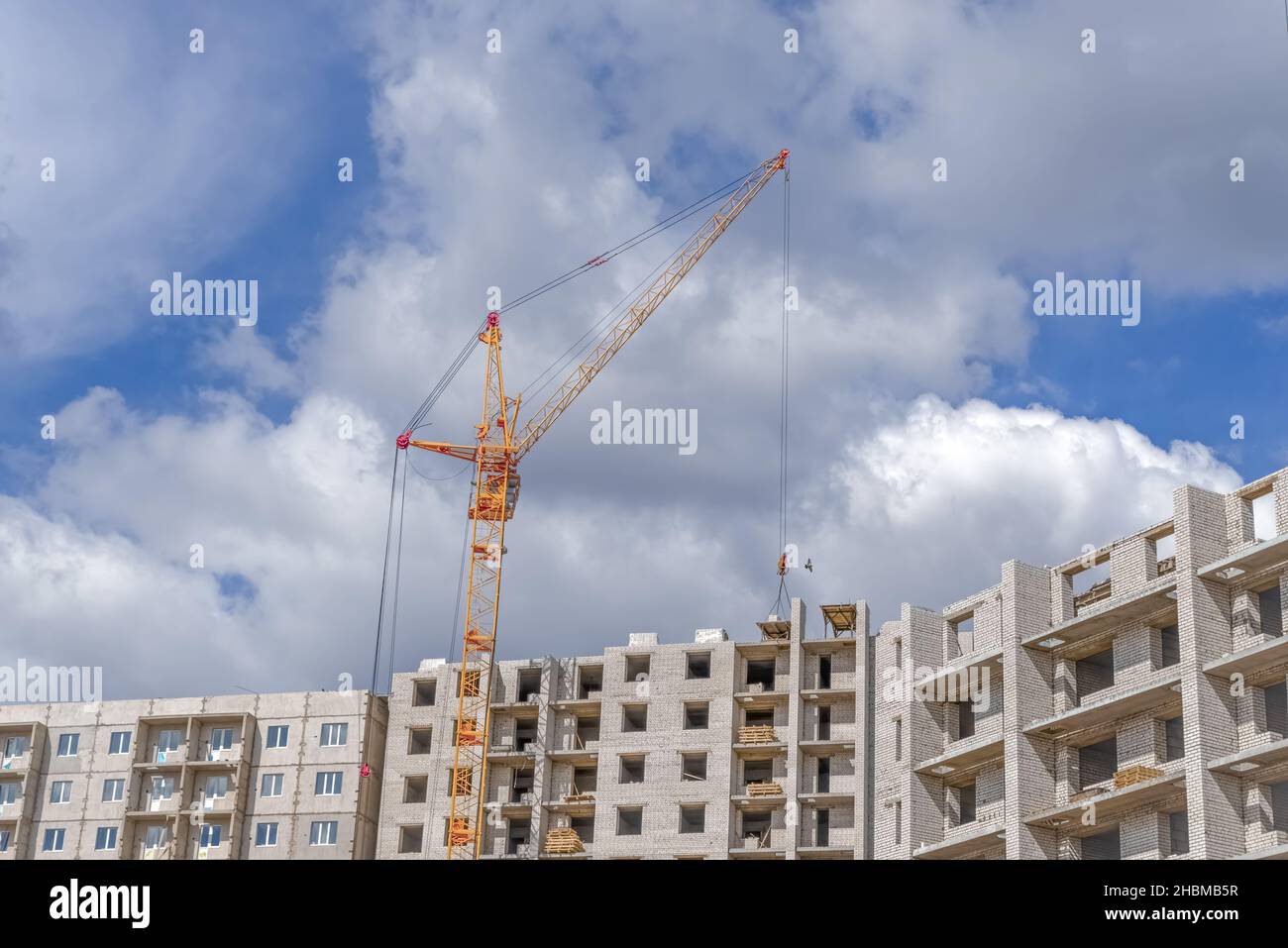 New multistorey building and lifting crane Stock Photo