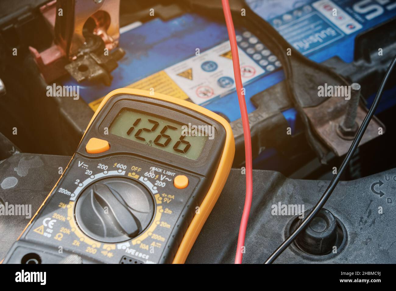 Mechanicl man uses electric multimeter voltmeter to check the voltage