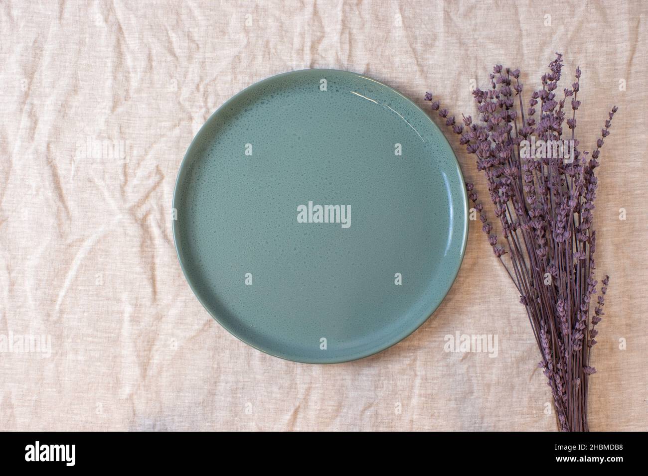 Green colored circle shaped ceramic plate on isolated background, food mockup Stock Photo