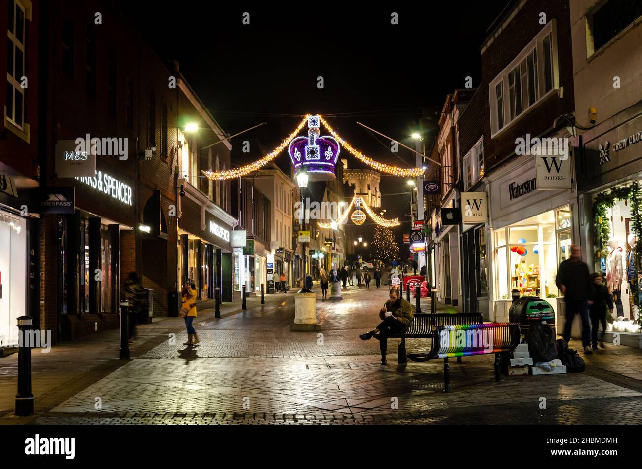 Christmas decorations lit up in the dark adorn Peascod Street in Windsor, UK during the festive season,. Stock Photo