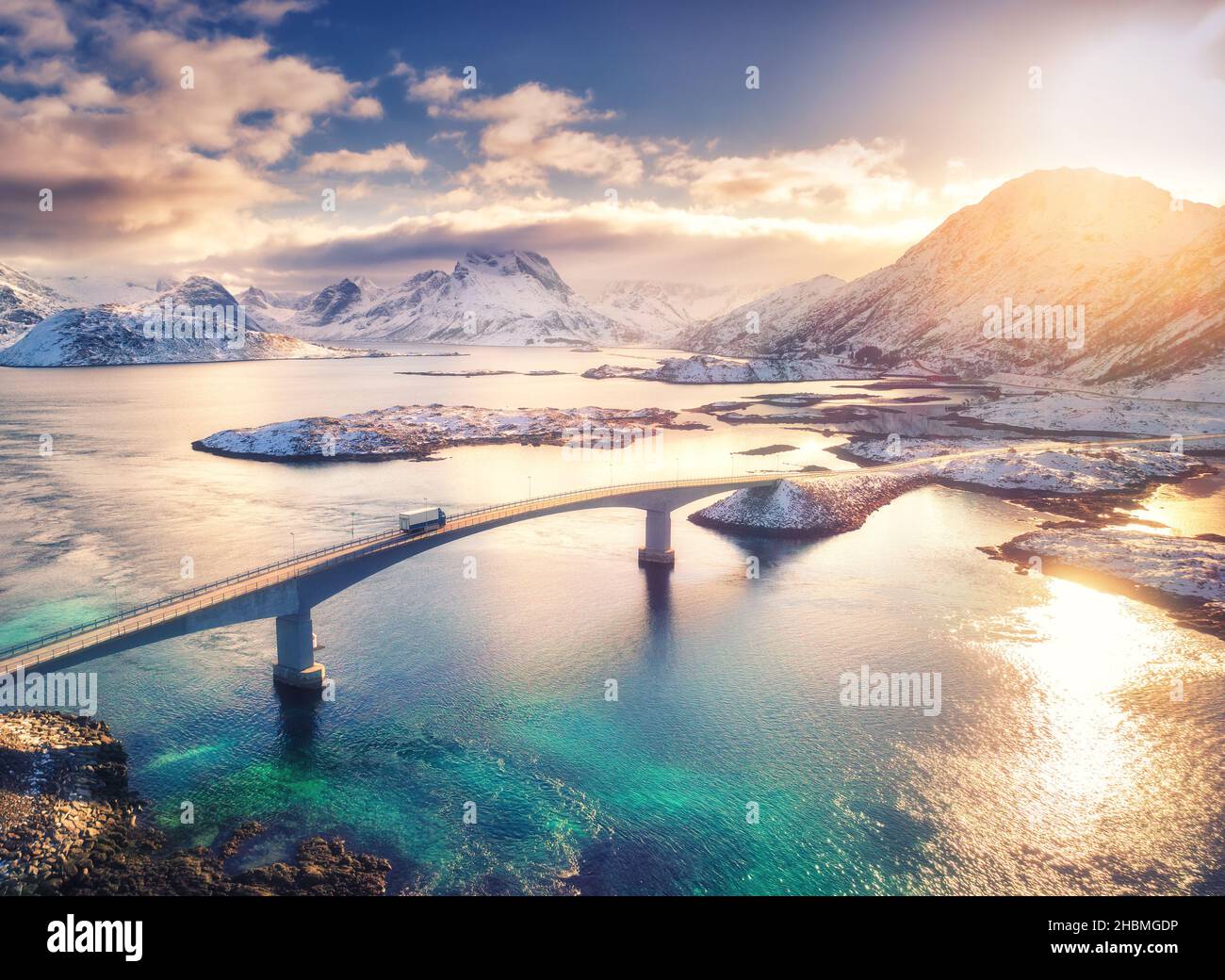 Aerial view of bridge, sea and snowy mountains in Lofoten Islands