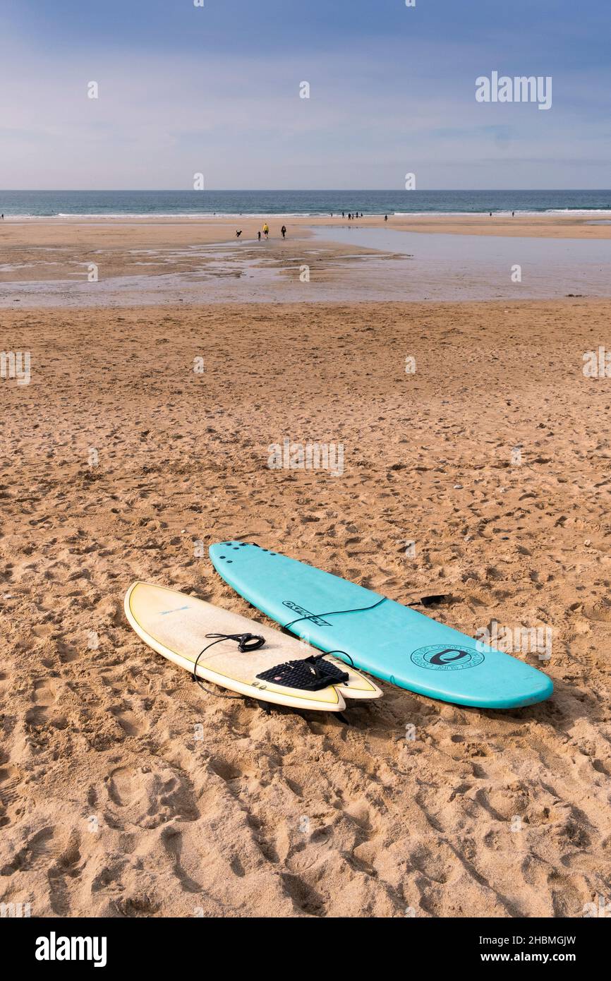 Surfboards lying on the sand at a deserted Fistral Beach in Newquay in