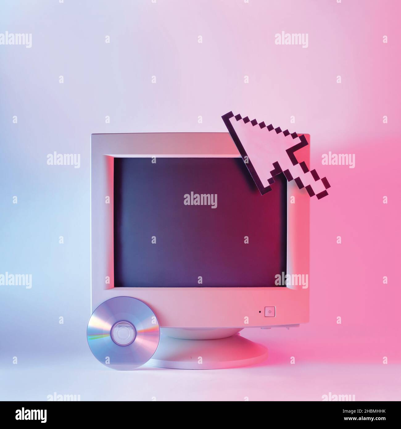 Old monitor retro computer cd disk and mouse cursor in vaporwave and neon light Stock Photo