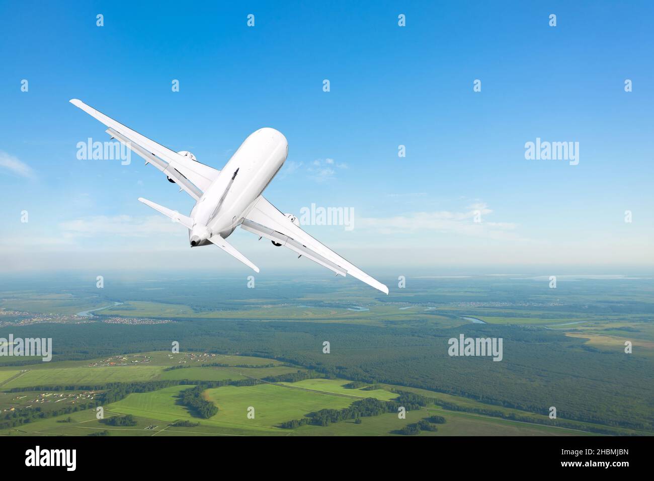 Airplane flies gaining height above ground clear sky Stock Photo Alamy