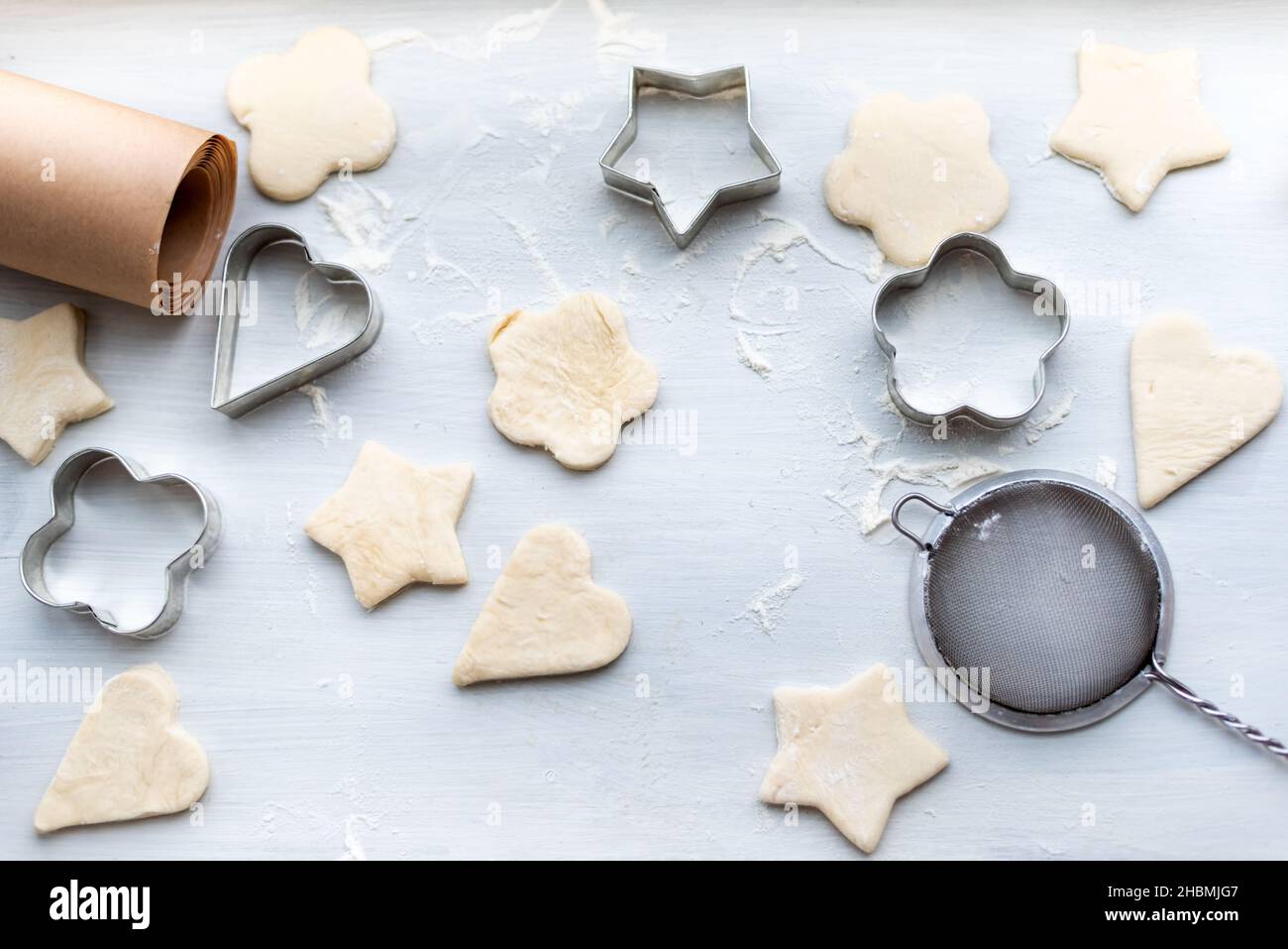 Top view of cooking a gingerbread cookie in the form of heart, star, cloud and flower. Christmas and New Year concept, festive preparations for winter Stock Photo