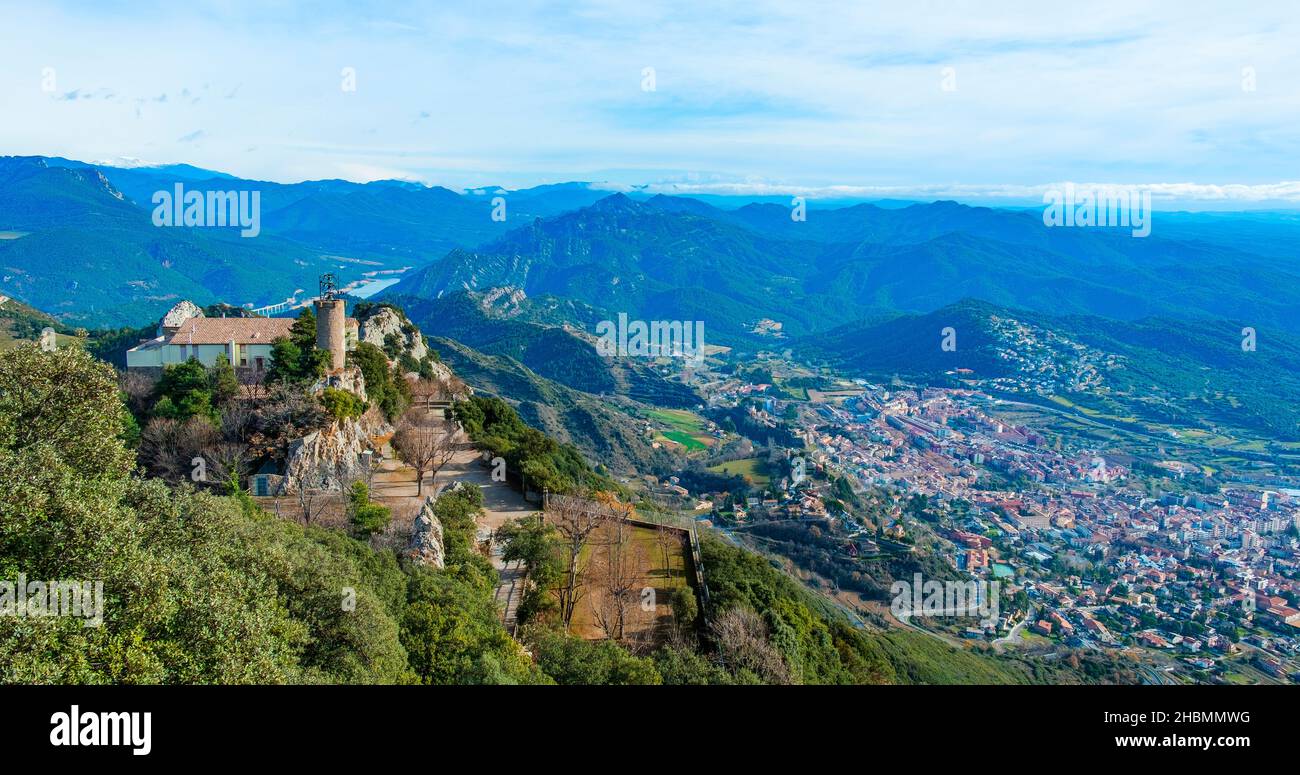 a panoramic view of the Serra de Queralt moutain, in Berga, Catalonia, Spain, highlighting the Mare de Deu de Queralt Shrine on the left and the town Stock Photo