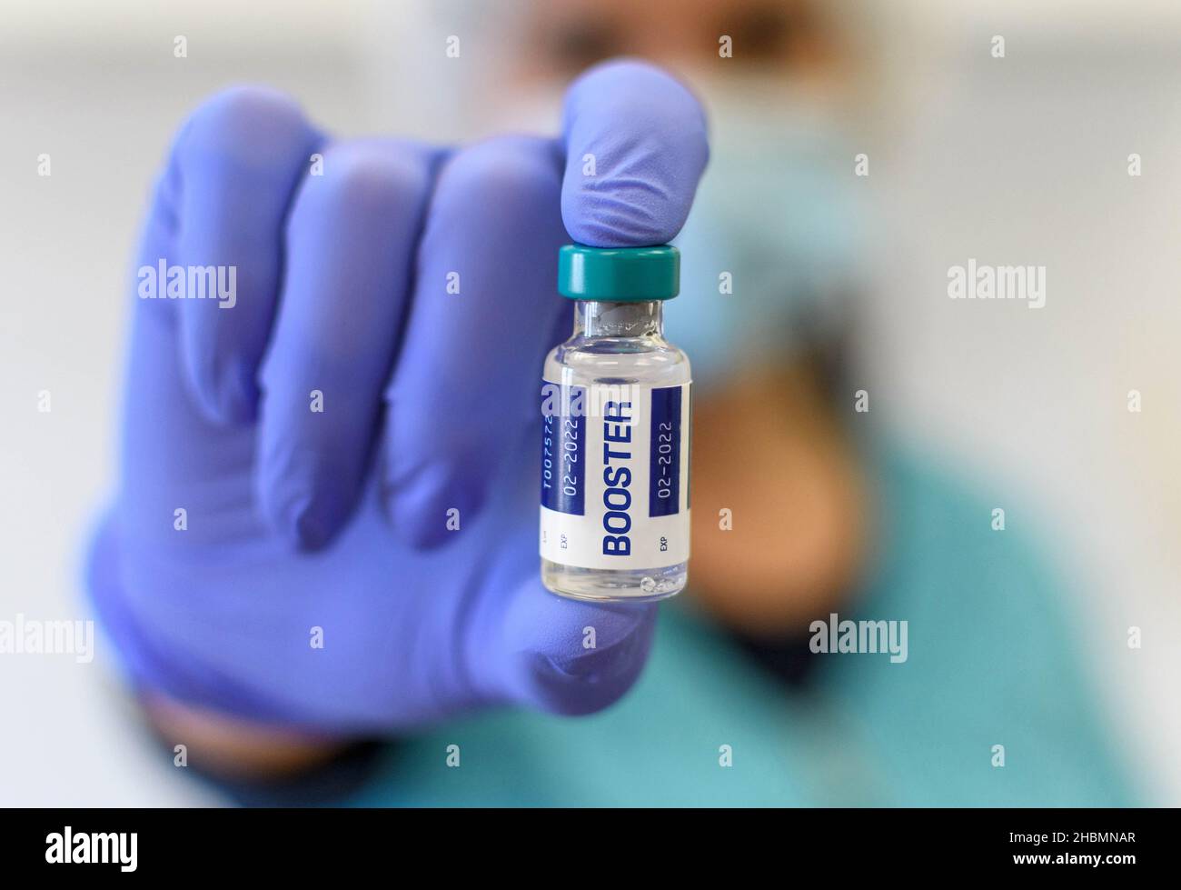 Finding Booster Close-up cropped photo of doctor holding covid vaccine vial with ...