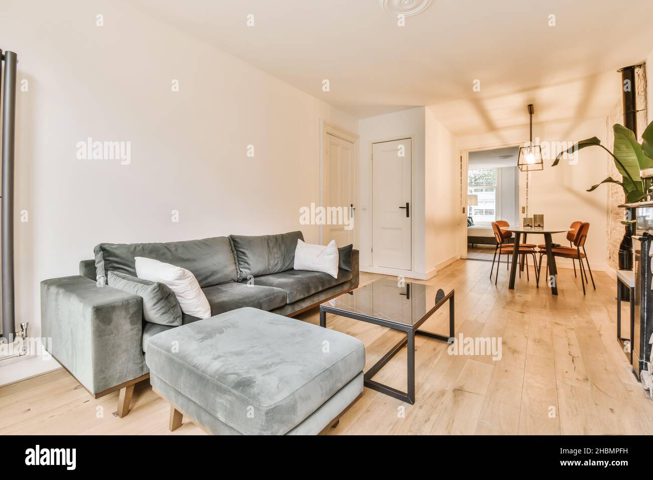 Living area with velvet soft brown sofas and an unusual coffee table Stock Photo