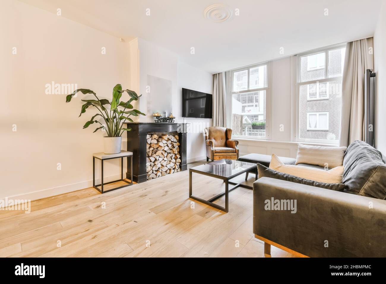 Living area with velvet soft brown sofas and an unusual coffee table Stock Photo