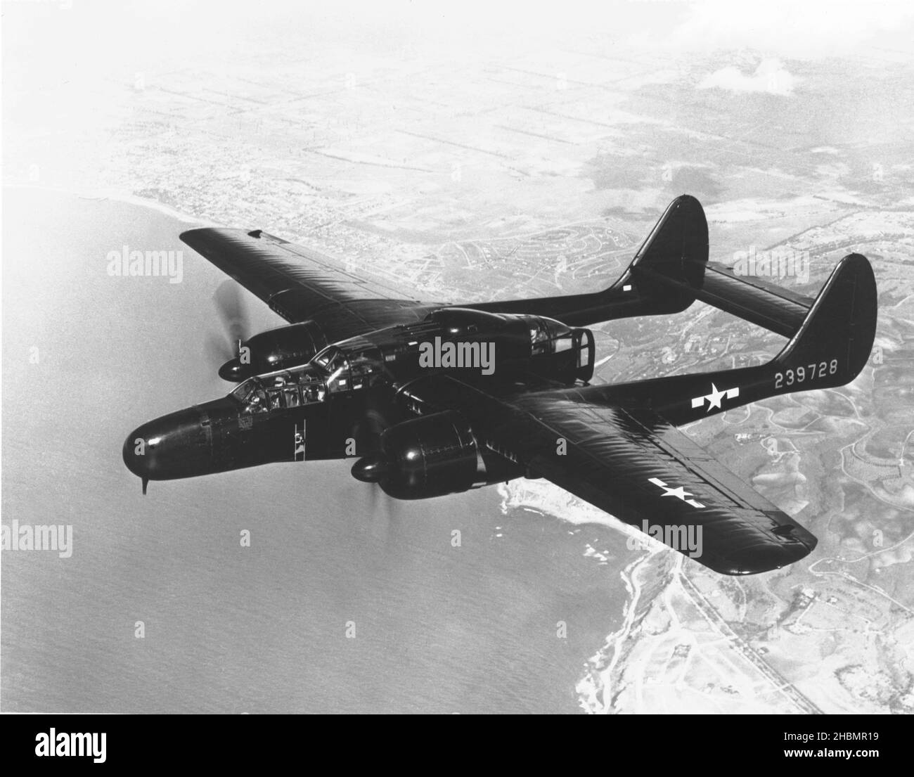 P-61 Black Widow US Military Aircraft Flys Over Land And Sea Stock Photo