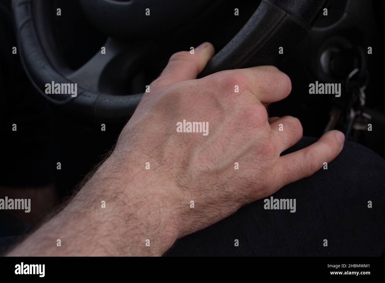hand holds the steering wheel of a car, driving a car Stock Photo Alamy