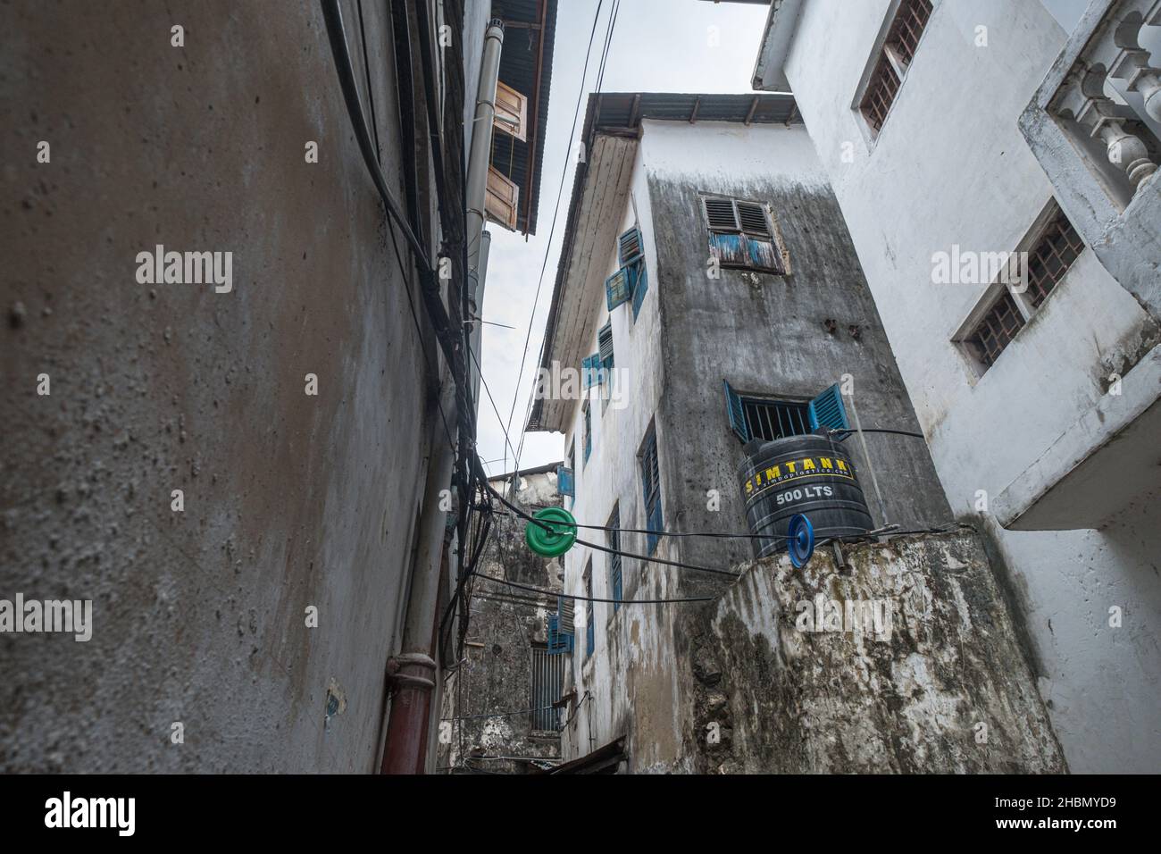 STONE TOWN, ZANZIBAR, TANZANIA - MARCH 13, 2017: Water storage amidst historic dwellings in the heart of downtown Stone Town, Zanzibar, Tanzania Stock Photo