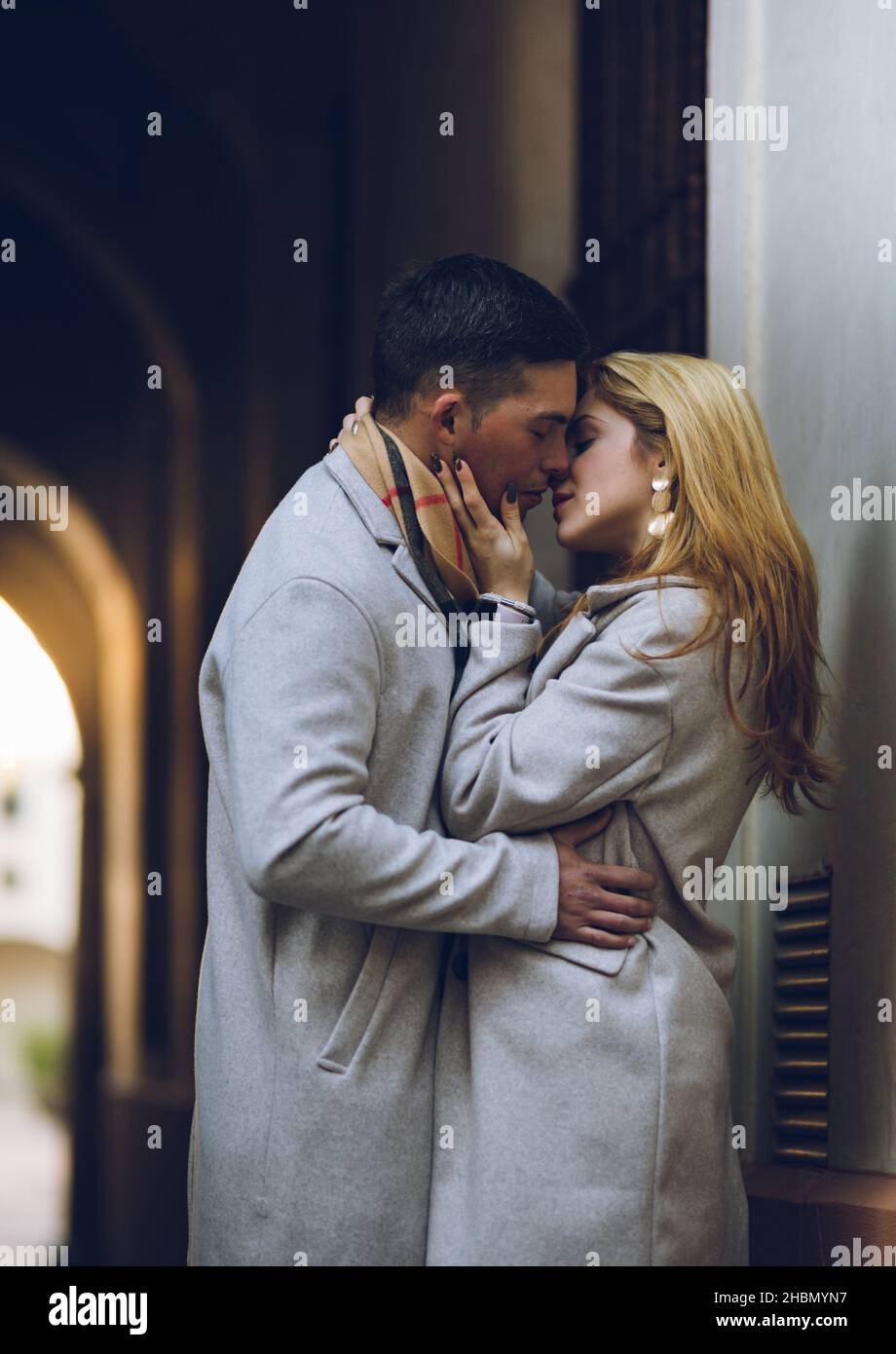 Young couple in love kissing on the street (vertical image) Stock Photo
