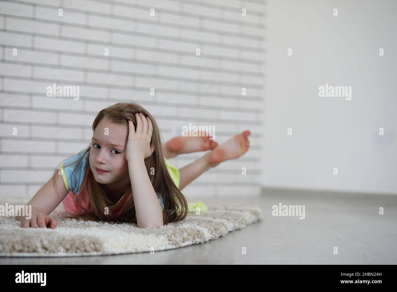 little girl lies on the floor and eats an apple Stock Photo - Alamy