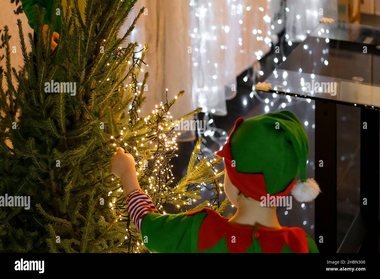 Dectrorting Little Tree Little kids decorating Christmas tree at home Stock Photo - Alamy