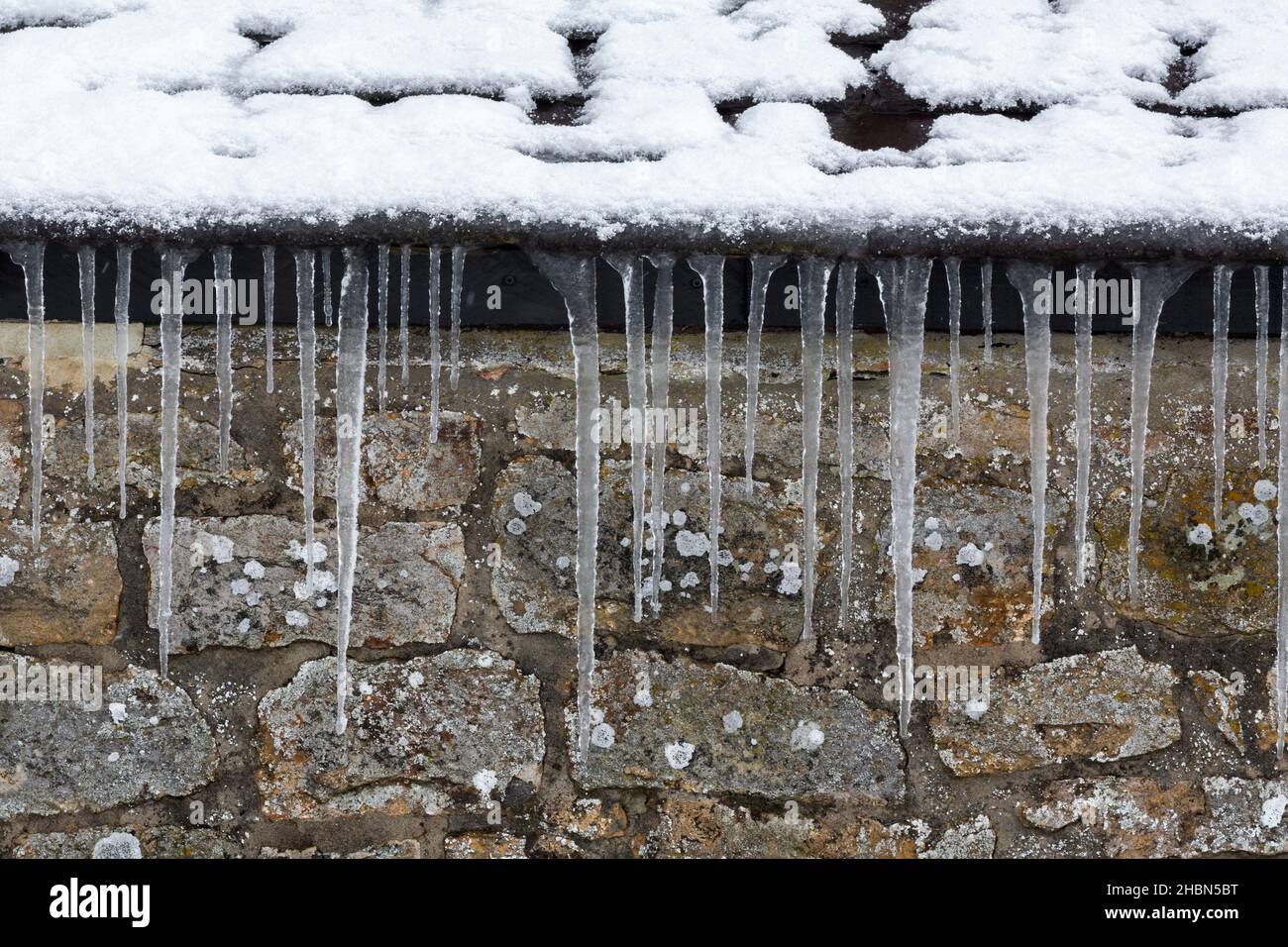 Icicles on roof in winter cold snap, UK Stock Photo