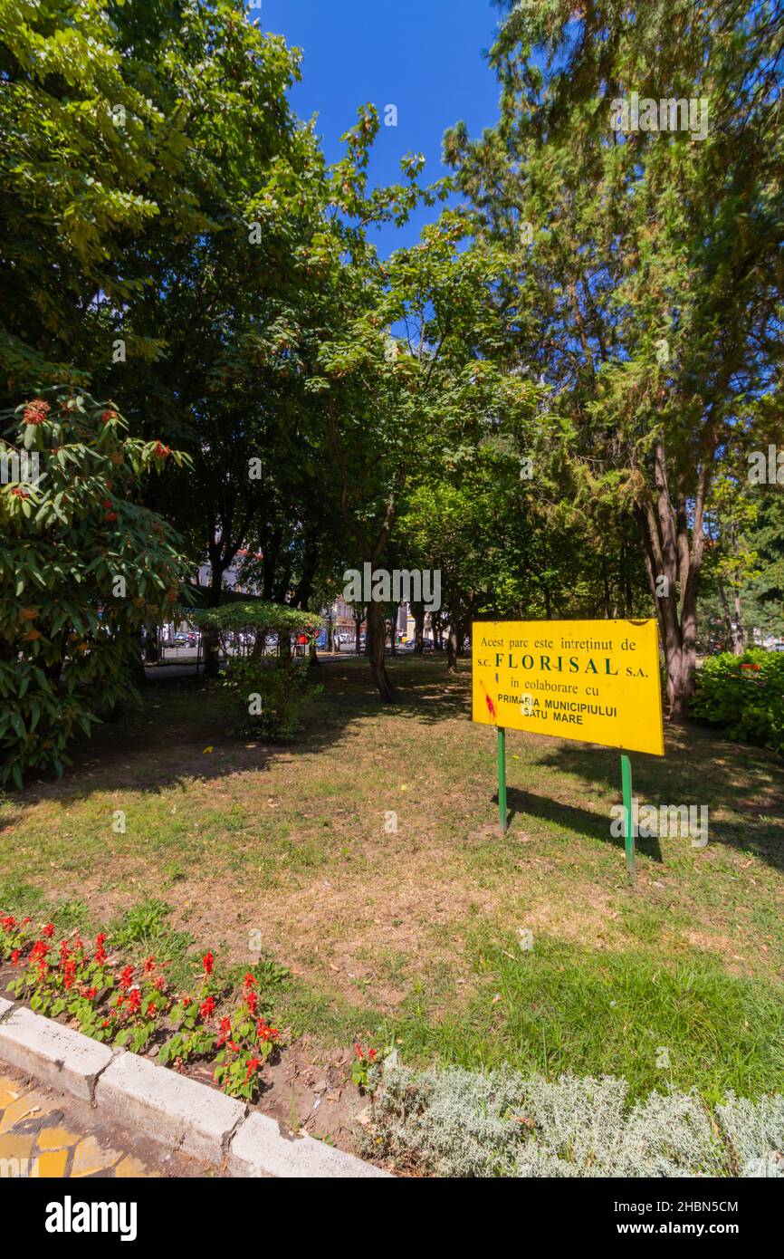 Satu Mare, Romania-August 20, 2021: Yellow billboard photographed in the park in the city center Satu Mare, Romania Stock Photo