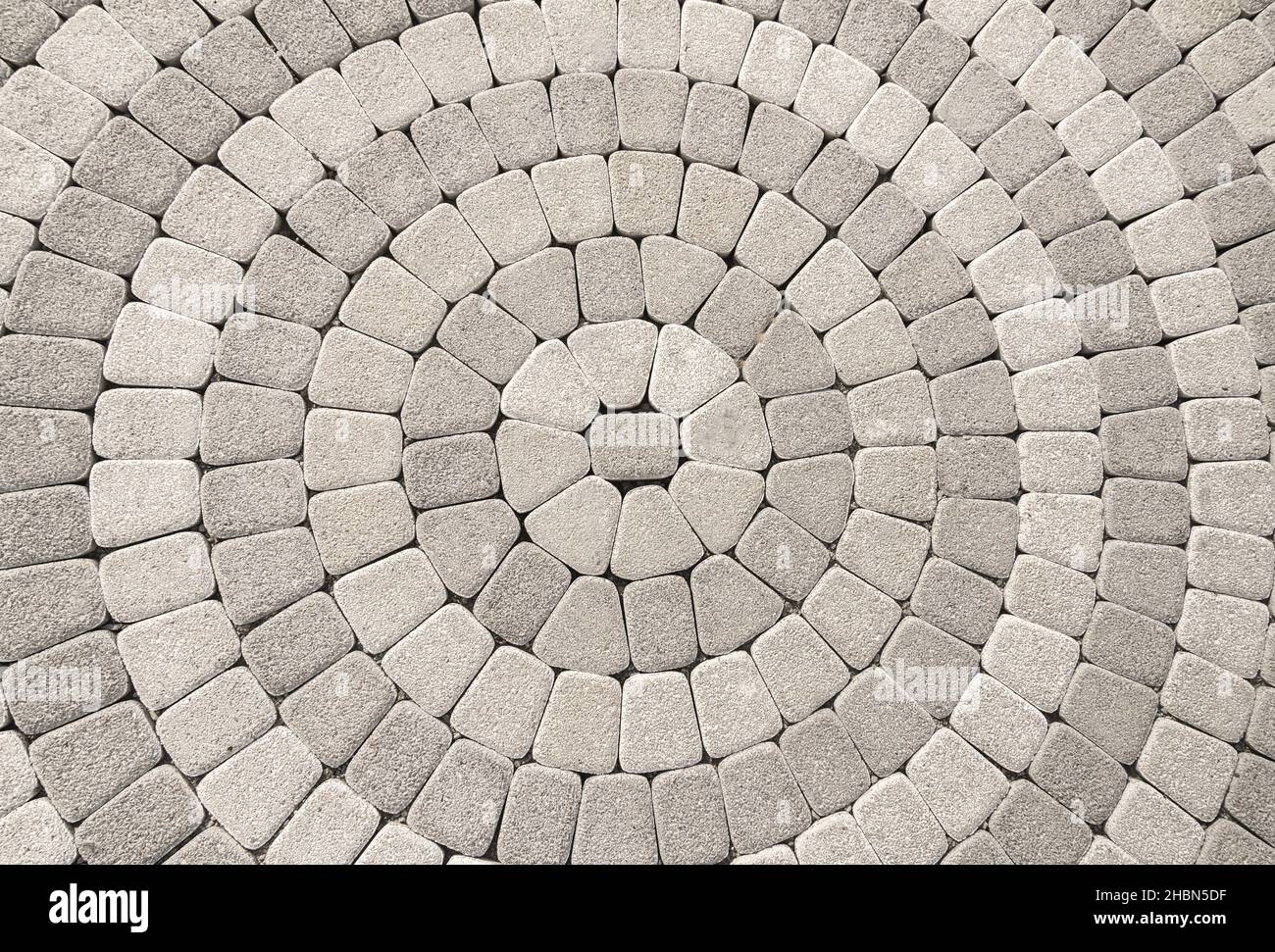 cobblestone pavement with circular pattern useful for background Stock