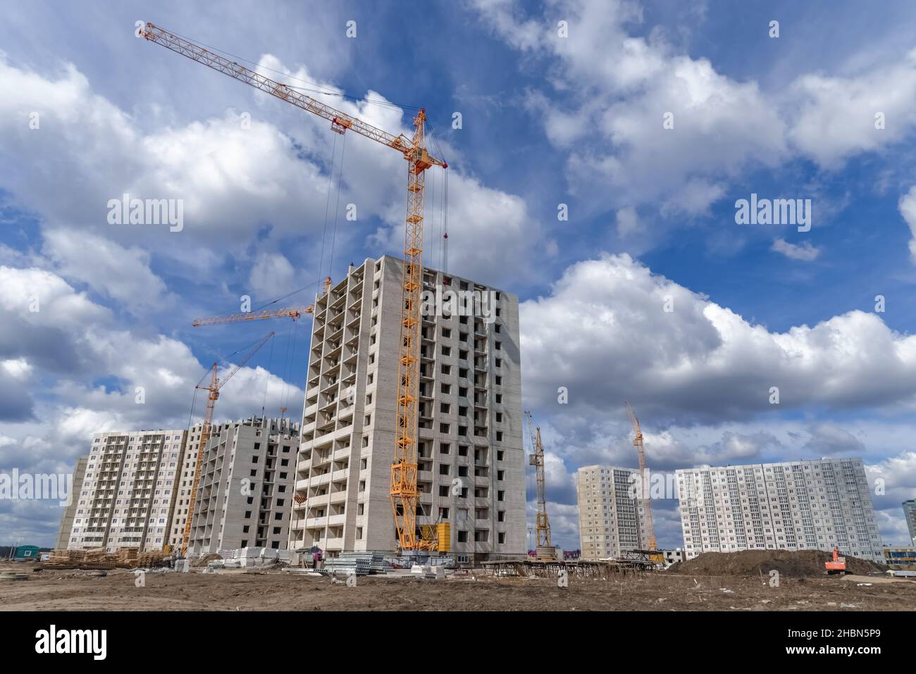Multistory building and industrial construction cranes Stock Photo