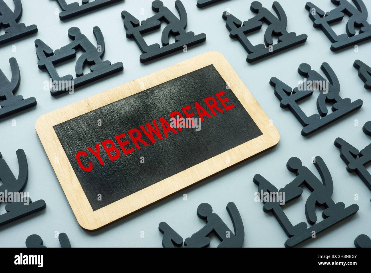 Cyberwarfare word on the plate and figures of hackers. Stock Photo