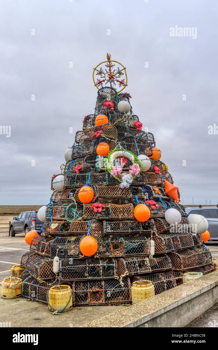 Christmas tree on the harbour at Wells-next-the-Sea in north Norfolk made out of crab and whelk pots from the local fishing fleet. Stock Photo