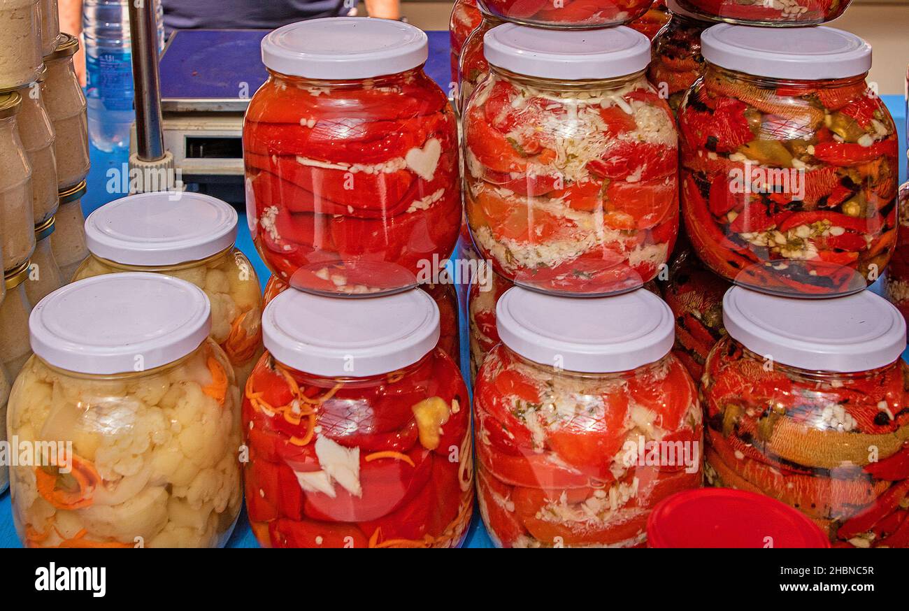 Homemade pickled vegetables food storage in glass jars sold on market Stock Photo