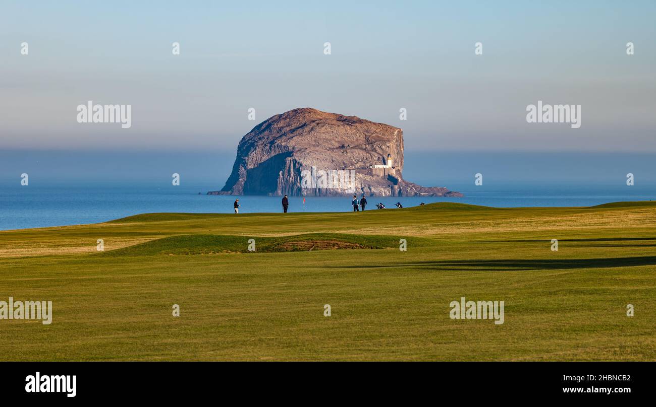 Men playing golf on Glen golf course, North Berwick in front of Bass Rock, Firth of Forth, Scotland, UK Stock Photo