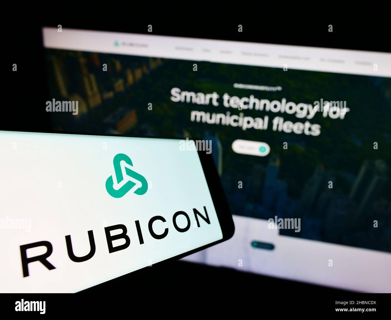Smartphone with logo of US software company Rubicon Technologies LLC on screen in front of business website. Focus on center of phone display. Stock Photo