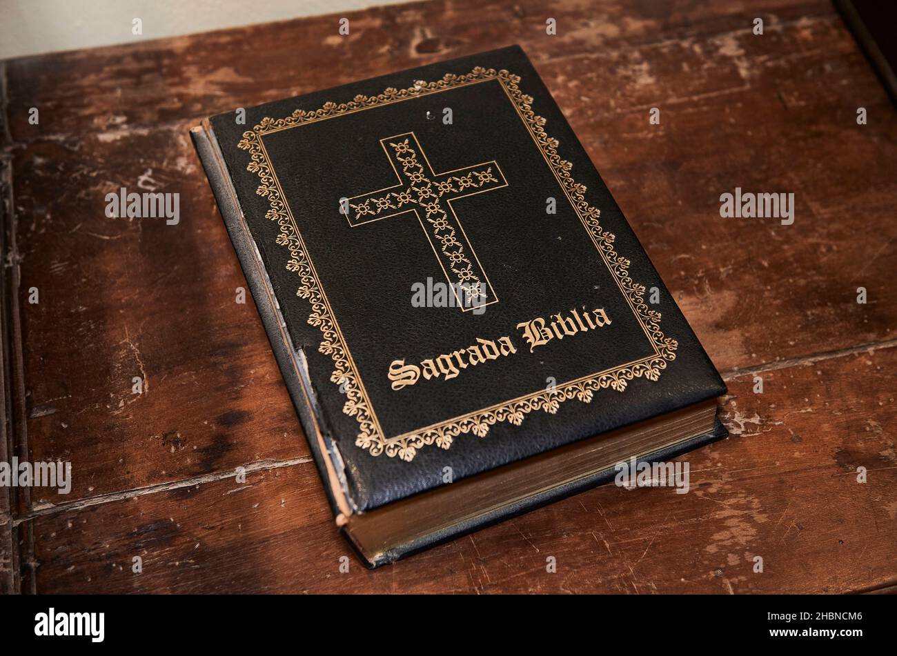 Much used book of the holy bible on wooden desk Stock Photo