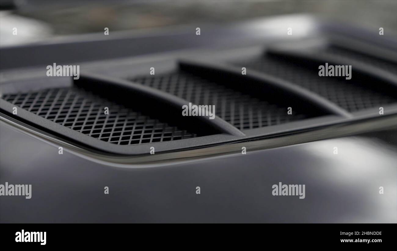 Air intake in the carbon hood of sport car. Luxury car exterior details