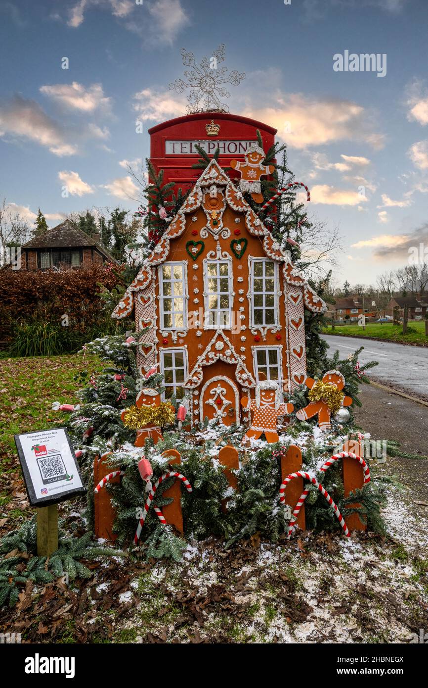 Compton, Surrey, England, UK. December 20th, 2021. For the Christmas season, the red phone box in the Surrey village of Compton has been decorated as a Gingerbread House in aid of Crisis, a charity for the homeless. Stock Photo