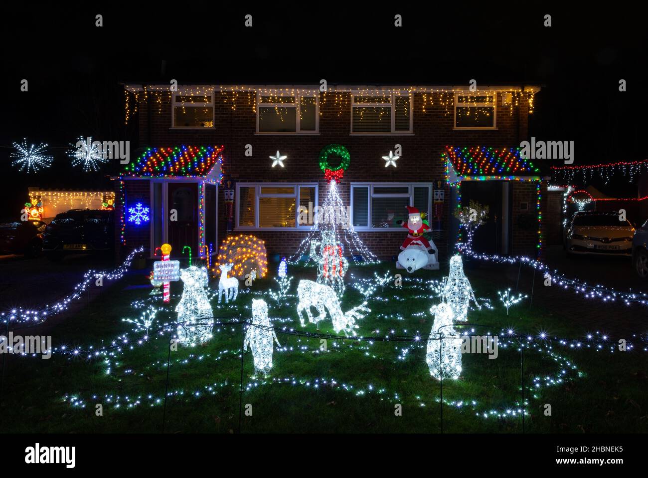 Guildford, Surrey, England, UK. December 20th, 2021. Two houses on Grange Road have been decorated with an impressive Christmas lights display (known locally as Christmas Corner), a fund-raising display in aid of Shooting Stars Children's Hospices. Stock Photo