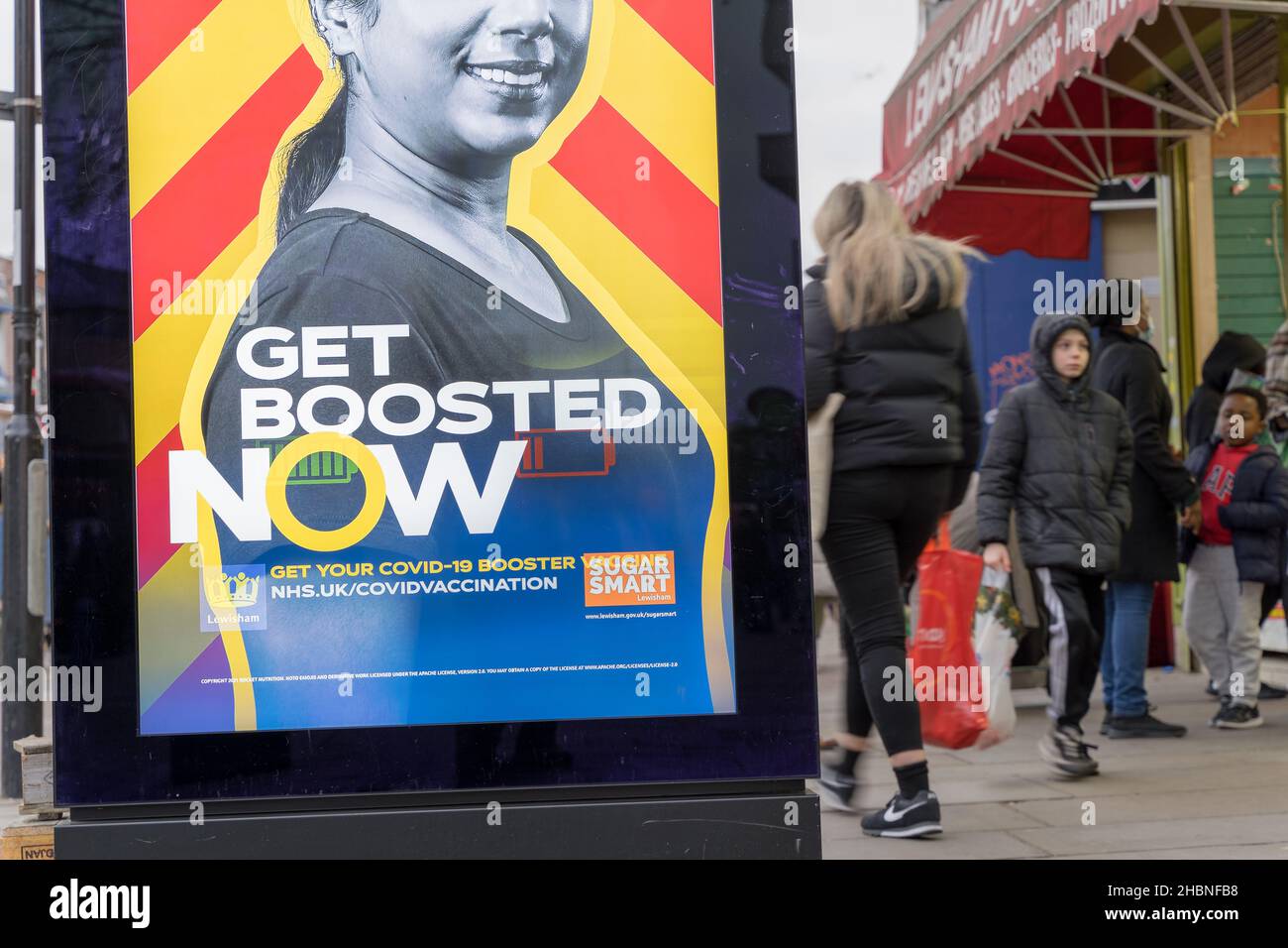 Get Boosted Now posters pop up in Lewisham town centre urging people to take up covid-19 booster jab before the end of the year. Stock Photo