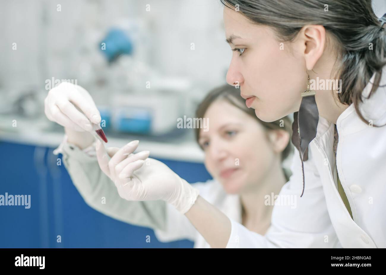 Two young female scientist doing experiments in lab. Close up Stock Photo
