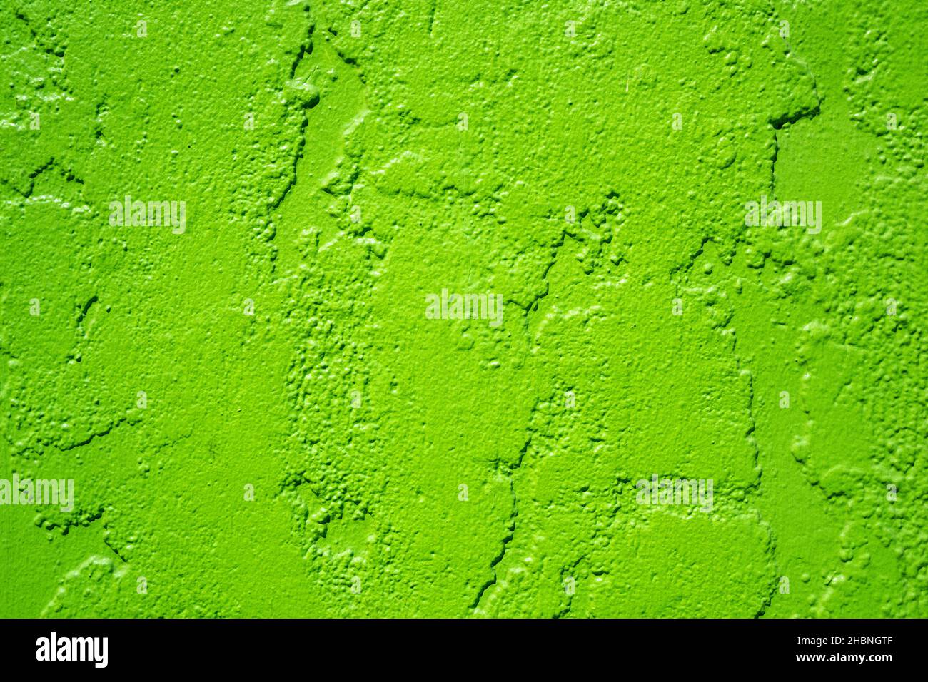 bright lime green painted stucco wall background Stock Photo