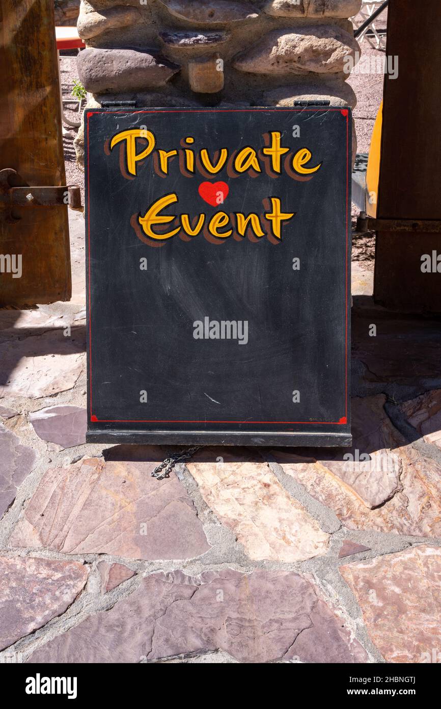 private event sign on a chalkboard with a red heart and yellow text Stock Photo