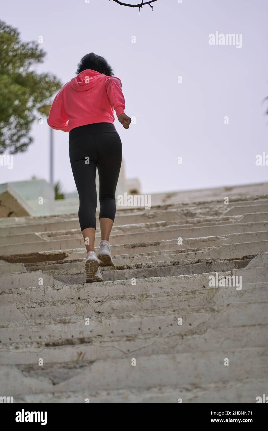 Woman performs leg exercises. Running up stairs. Sports Stock Photo Alamy