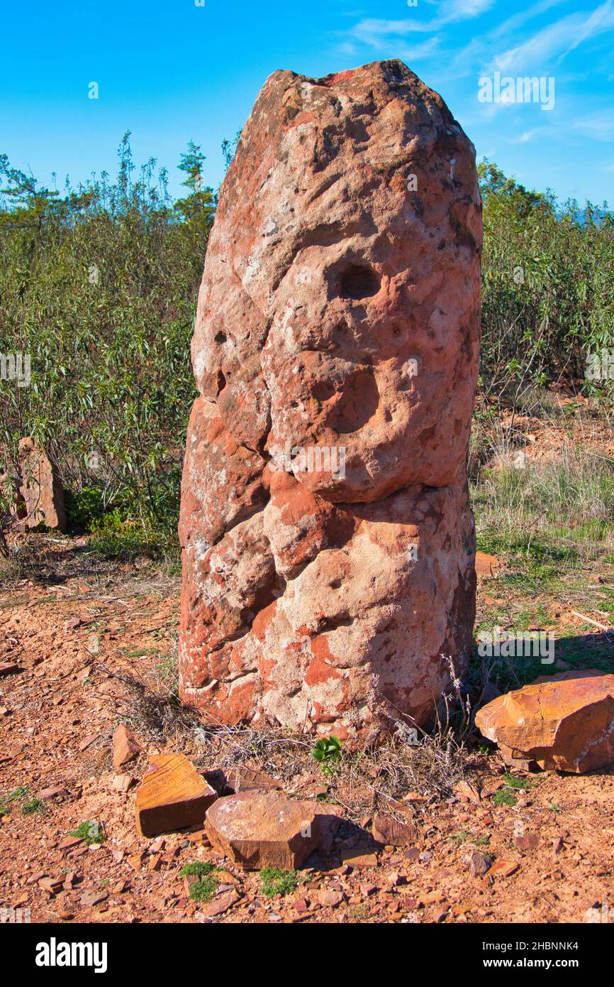 Sandstone menhir, dating from 6000-4500 BC, in the dry hills near Vale Fuzeiros, Algarve, Portugal. Stock Photo