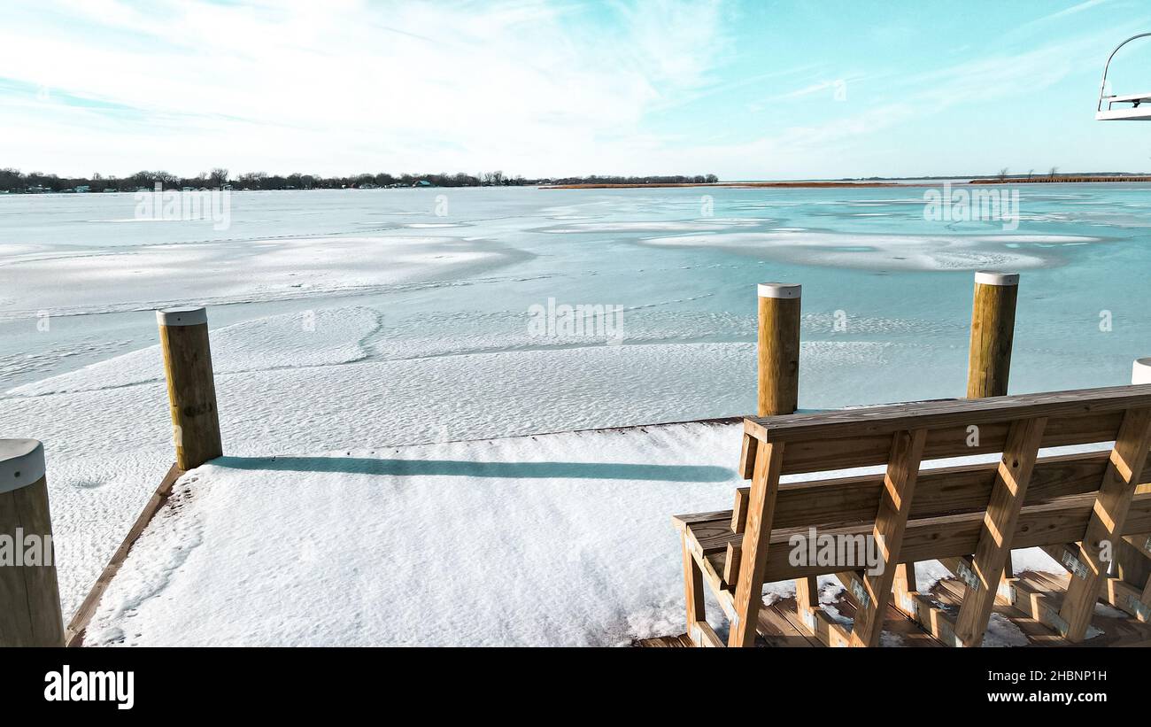 Take a seat on the bench and enjoy the view of frozen winter land. Lake